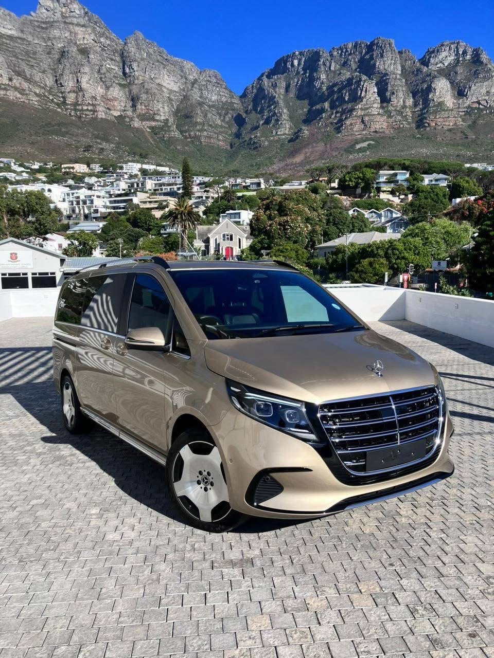 Luxury minivan with dramatic mountain backdrop on safari route
