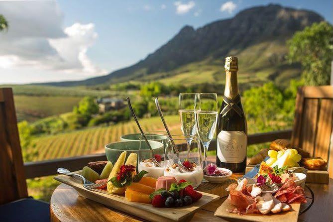 Vineyard table with wine and food overlooking the Cape Winelands
